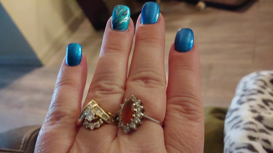 Close-up of polished nails on hands.